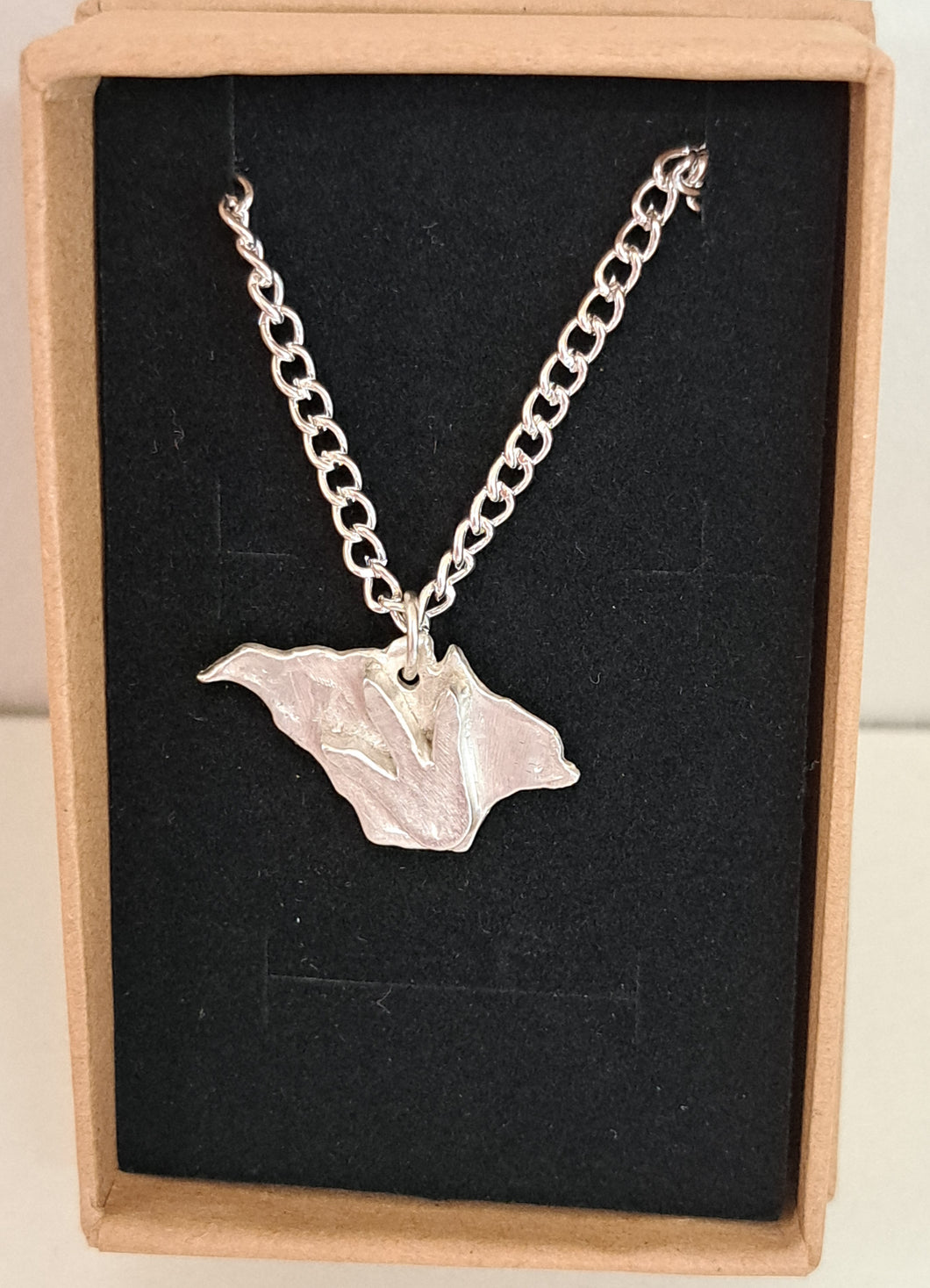 Silver Isle of Wight necklace with dinosaur footprint